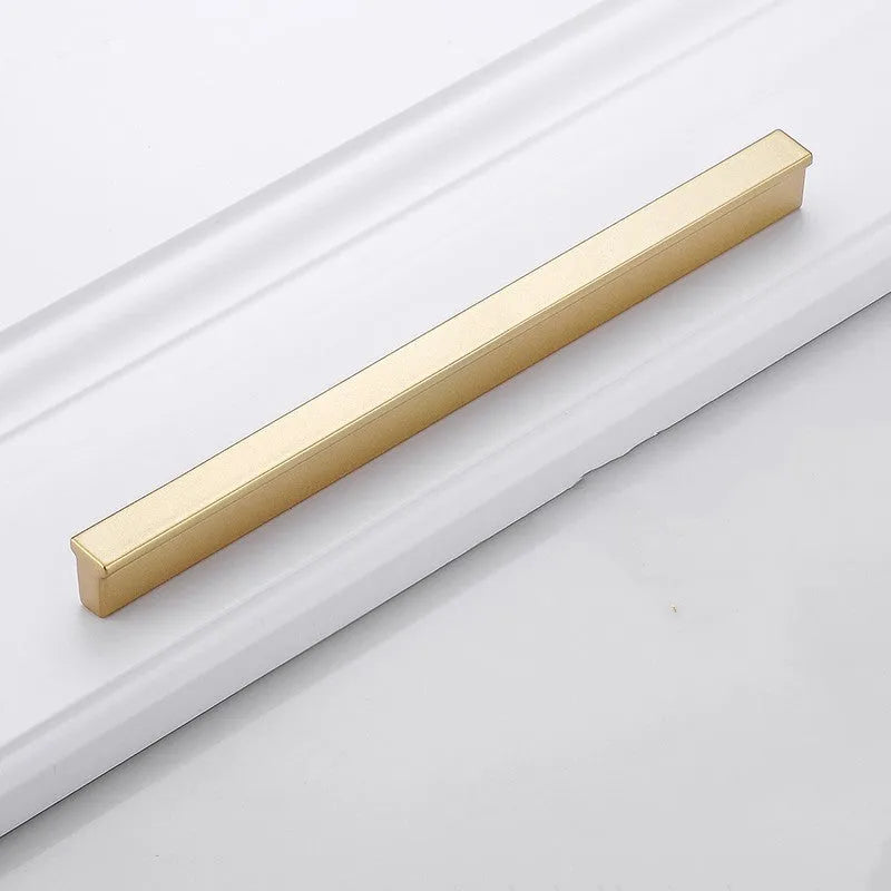 Gold coloured aluminium alloy T-shaped cabinet door handle showing single hole mounting.