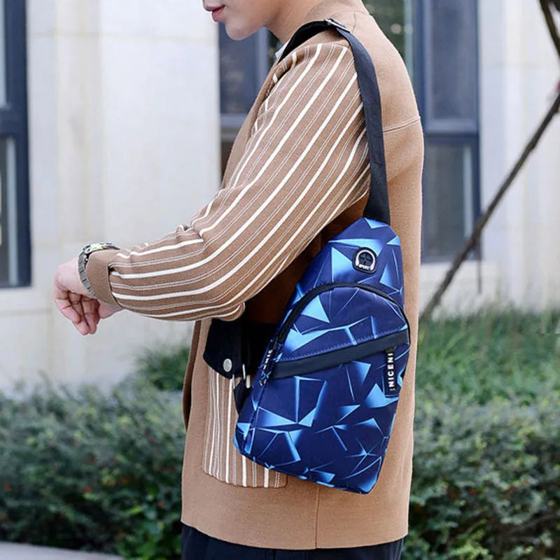 Men's black print sling chest bag with earphone hole and zipper, showing inner patch pocket.