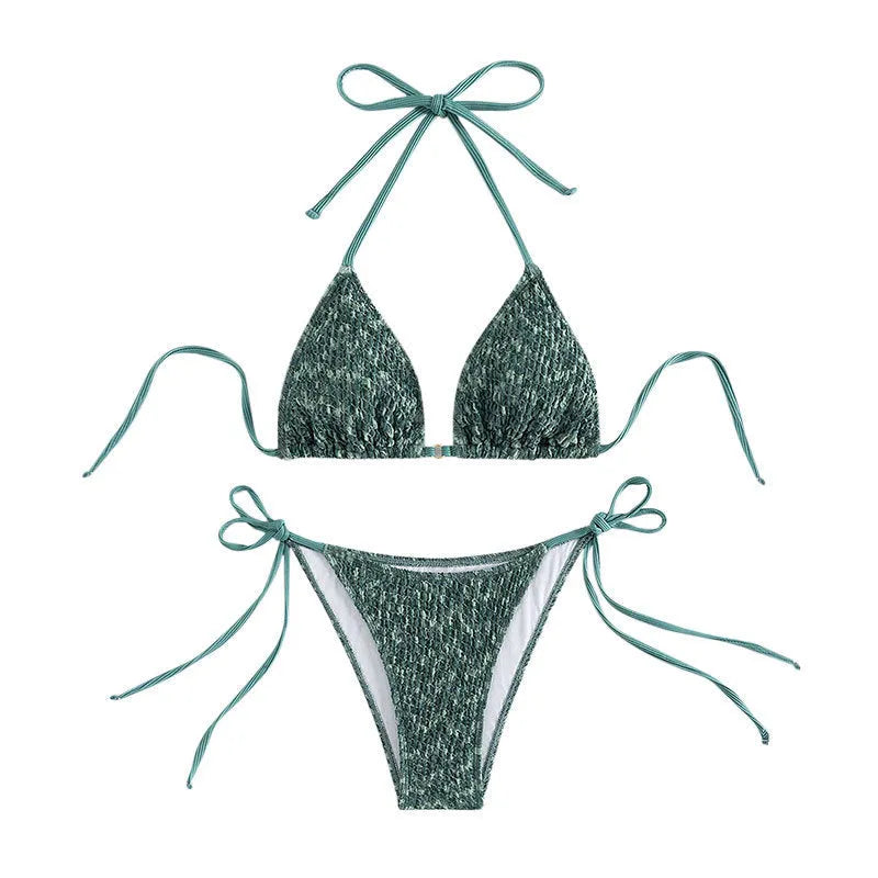 Green women's backless halter bikini set with shorts on a mannequin.