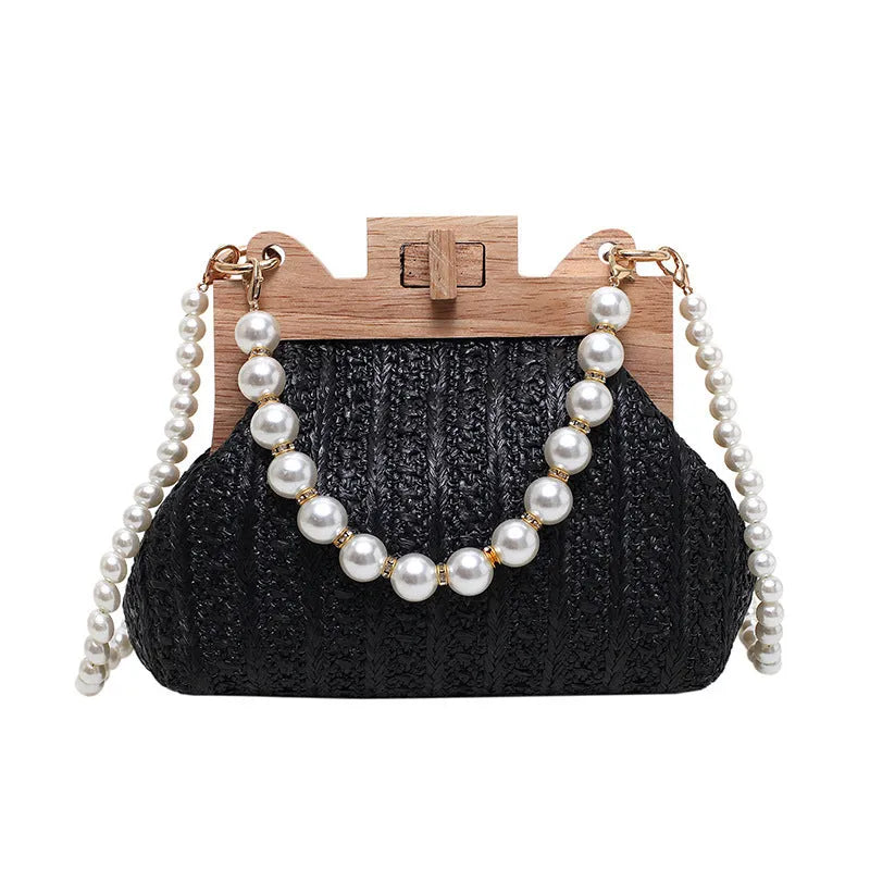 Women's straw woven shoulder bag with pearl chain detail showing interior organisation compartments