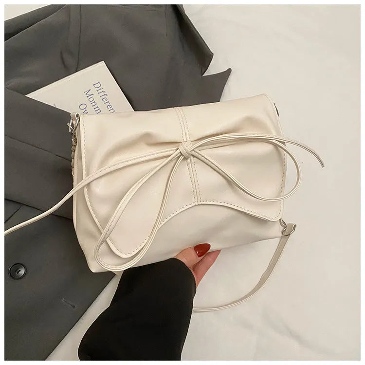 Women's black PU leather crossbody bag with a horizontal square shape and crossbody strap