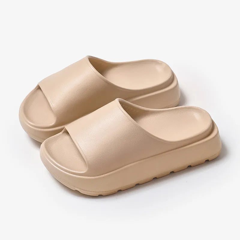 Women's beige fish mouth slippers with a thick 5.5cm EVA platform sole on a wooden floor.