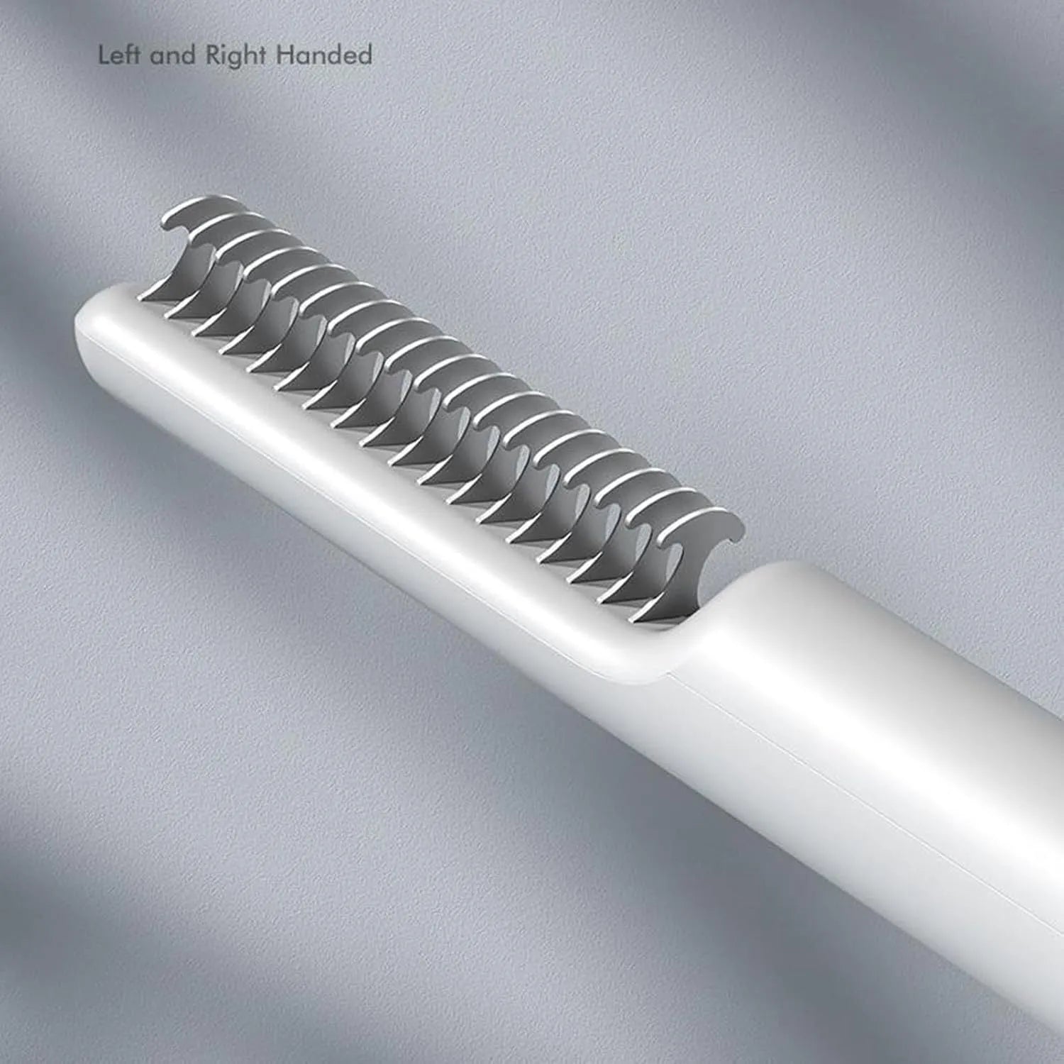 Pink and white stainless steel dematting comb for dogs with ergonomic handle on a plain background.