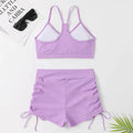 Women's black high waist split bikini swimsuit top and shorts laid flat.
