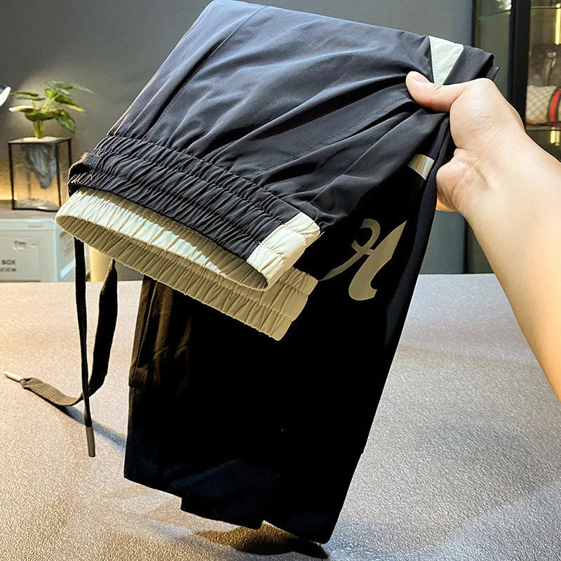 Black men's casual cropped trousers with banded ankle, made from ultra-thin ice silk cotton fabric.