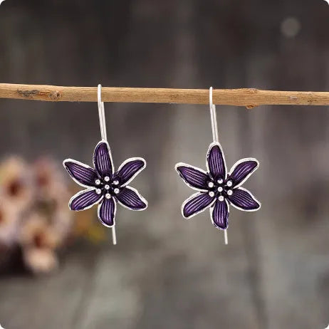 A pair of retro-style purple flower earrings made from lightweight alloy with an electroplated finish.