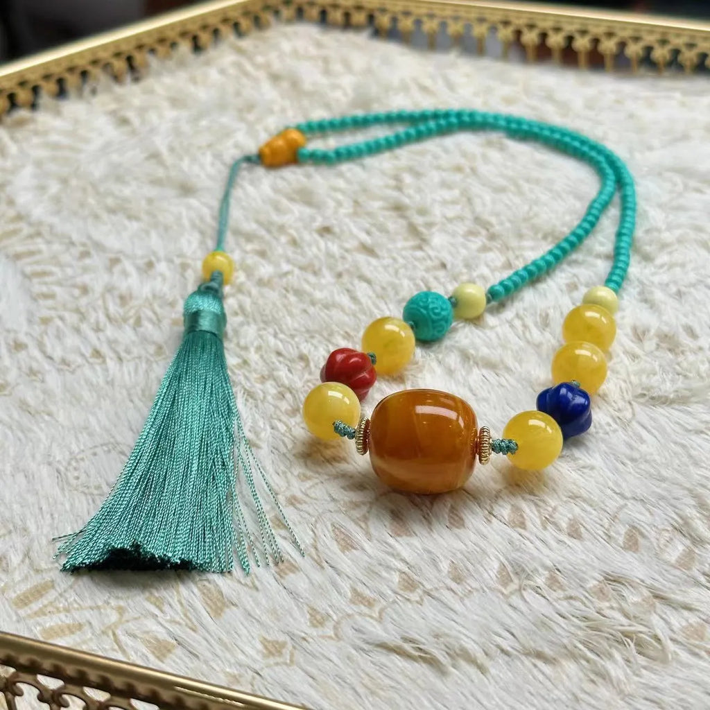 Turquoise lucky pendant necklace with hand-woven mesh flower stone design on a ball bead chain.