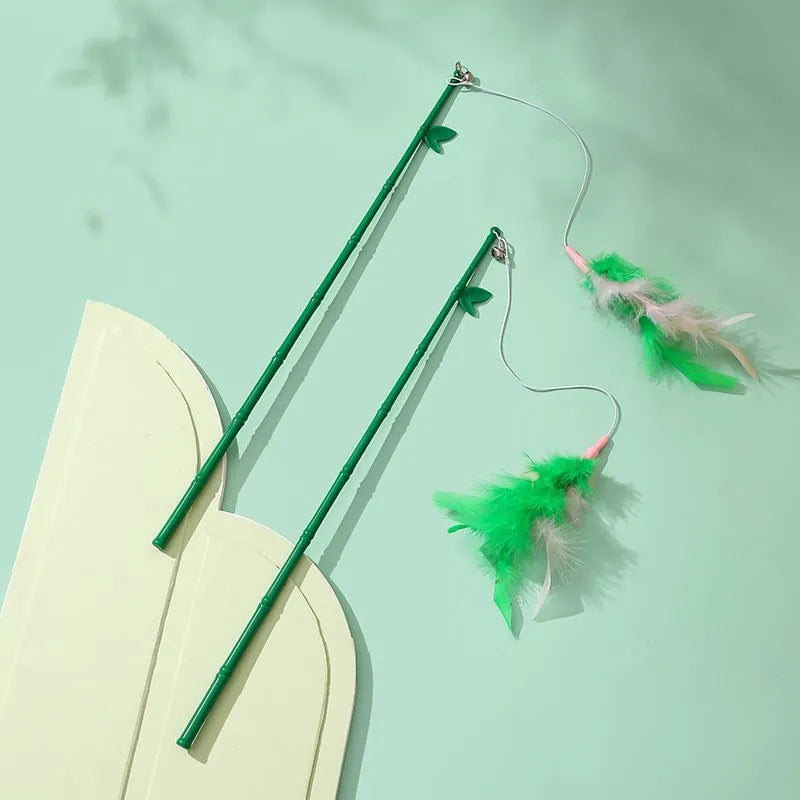 Green interactive cat feather wand toy with bells and feathers on a durable string