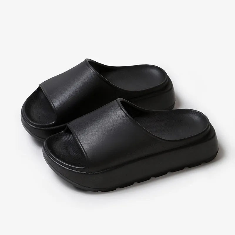 Women's beige fish mouth slippers with a thick 5.5cm EVA platform sole on a wooden floor.
