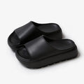 Women's beige fish mouth slippers with a thick 5.5cm EVA platform sole on a wooden floor.