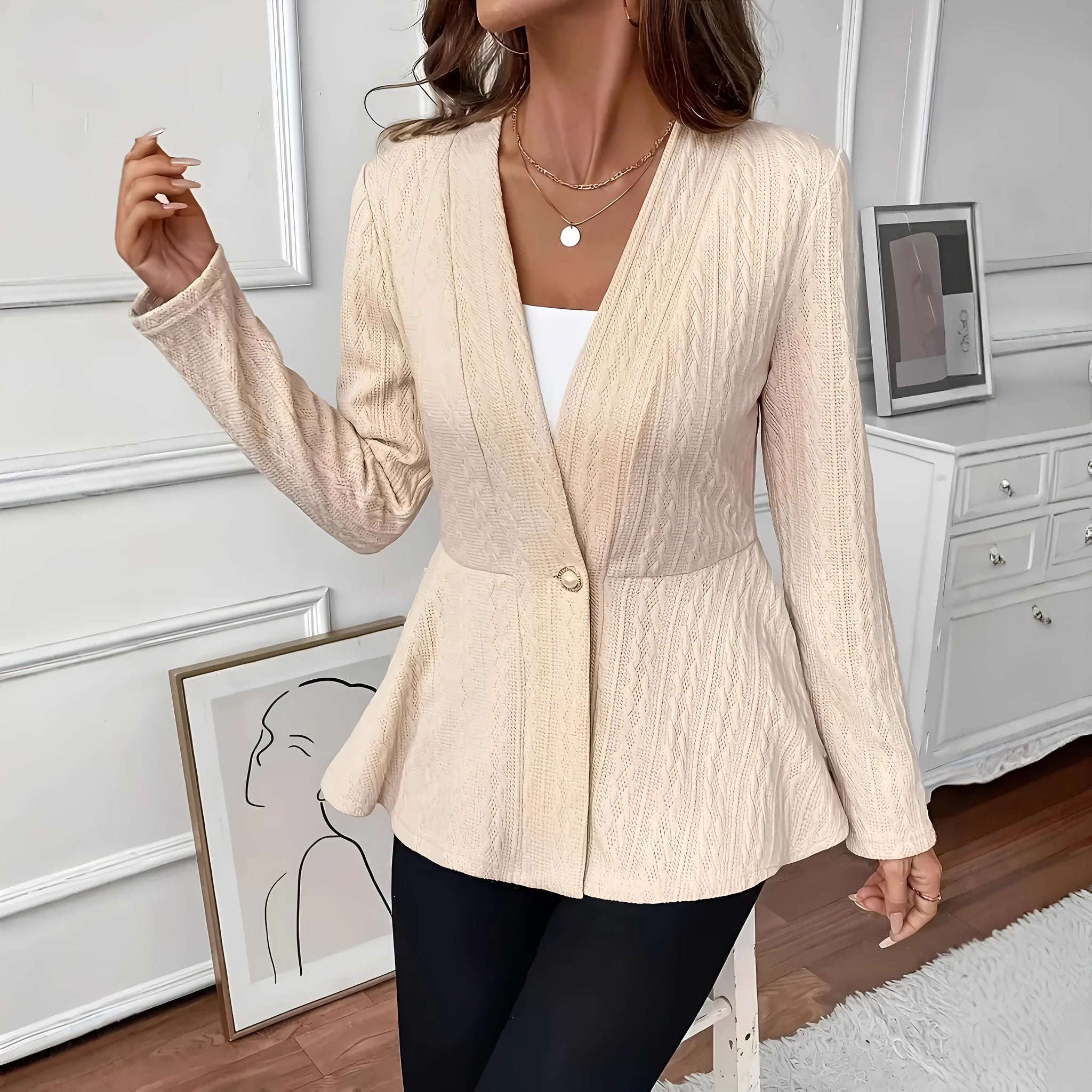 Women's apricot coloured Jacquard patterned knitted cardigan with one button, shown on a model.