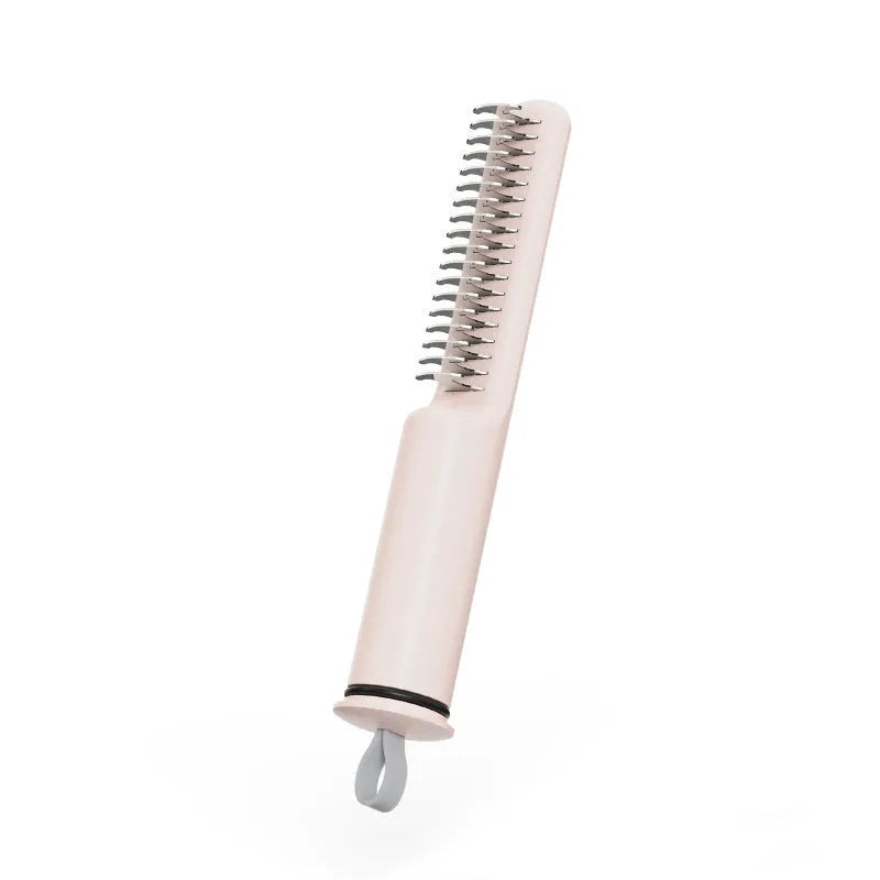 Pink and white stainless steel dematting comb for dogs with ergonomic handle on a plain background.