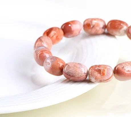 Natural cherry agate bracelet with barrel shaped beads and carved Ruyi symbols