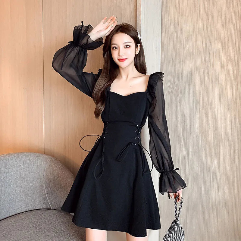 White women's long sleeve dress with chiffon patchwork detailing and a long, slimming skirt.
