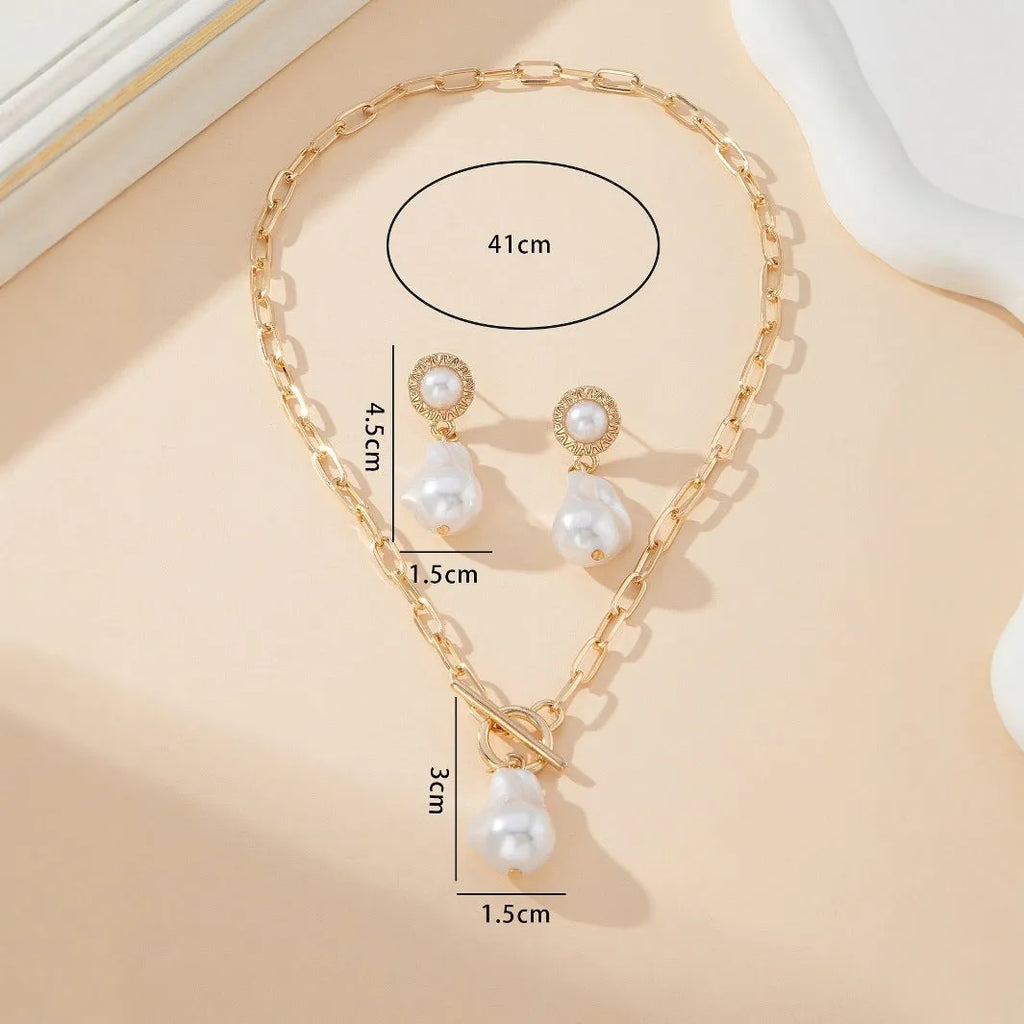 Gold-colour baroque pearl necklace and stud earrings jewellery set on display