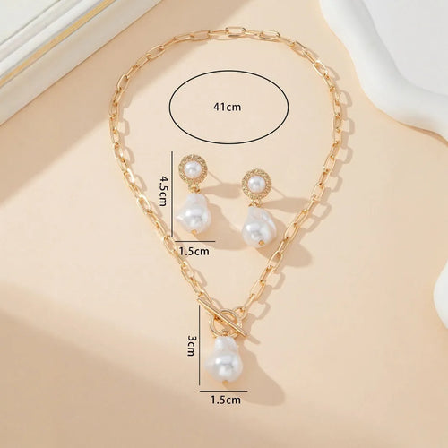 Gold-colour baroque pearl necklace and stud earrings jewellery set on display