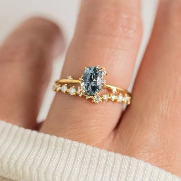 Gold plated women's ring with flower design and green zircon stones showing five available ring sizes