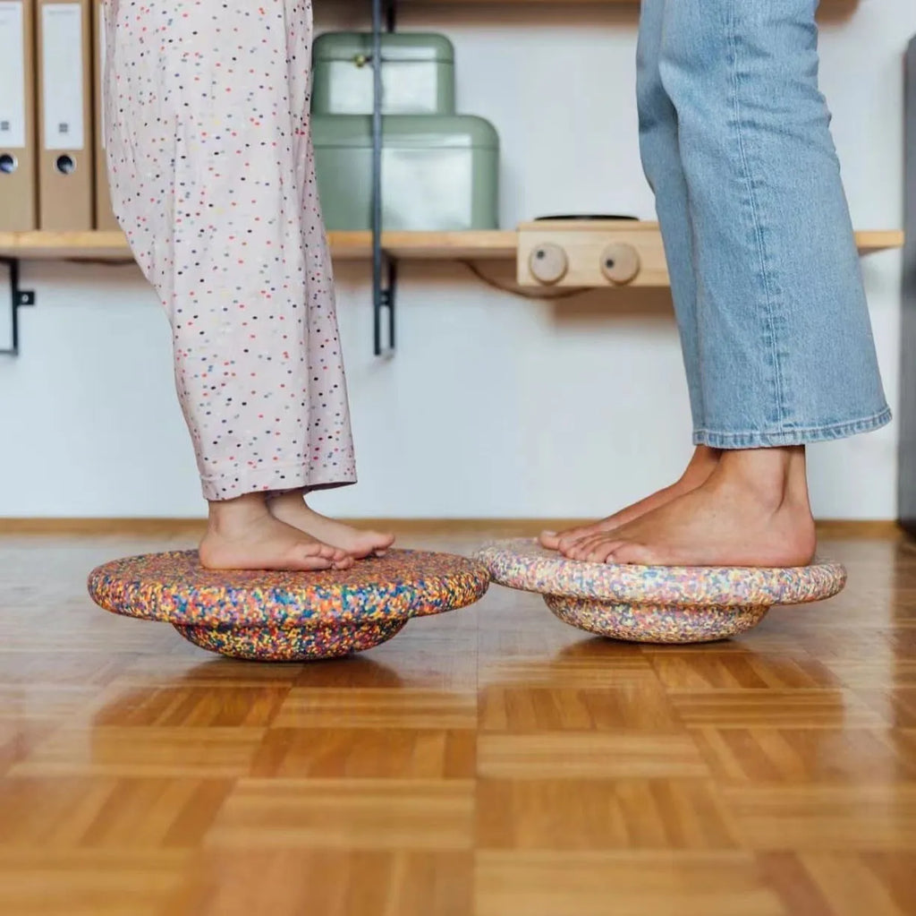 Plastic wood surf balance board for children, shown in mixed colour and black wood grain finishes.