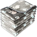 Coral fleece dog blanket with paw print design, shown in camel colour, size L (100x120 cm).