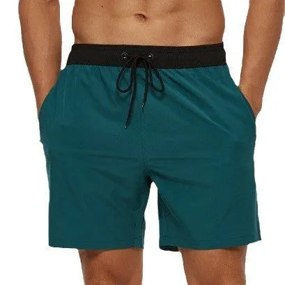 Men's blue athletic shorts with stitching waist detail, drawstring, zipper, and side pockets.