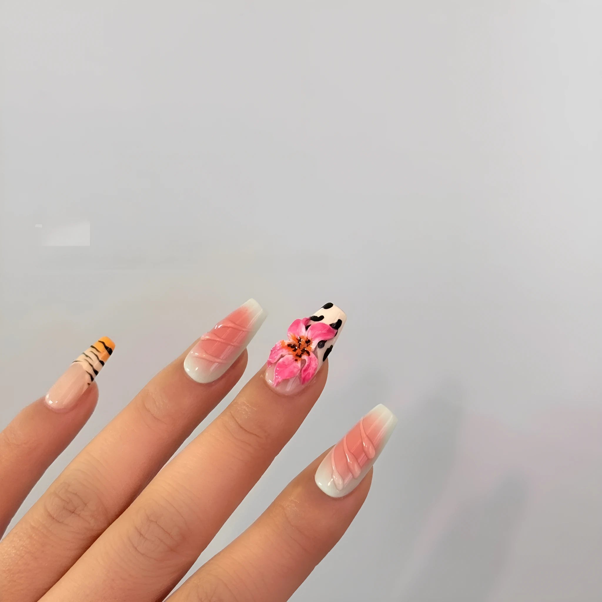 Embossed lily flower and leopard print zebra pattern nail art set showing dimensional texture and size variations