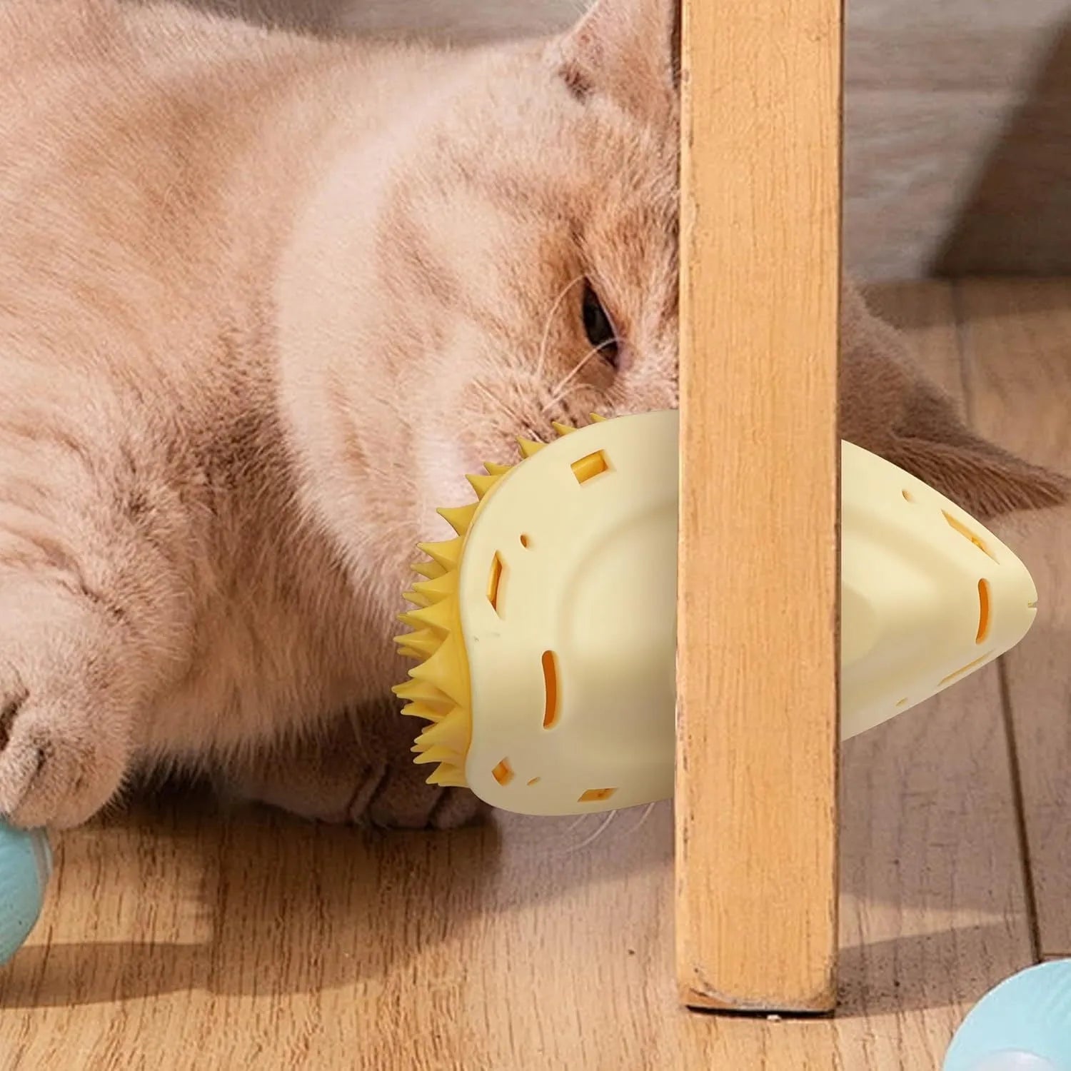 Yellow durian shaped cat corner scratcher mounted on a wall with adhesive backing