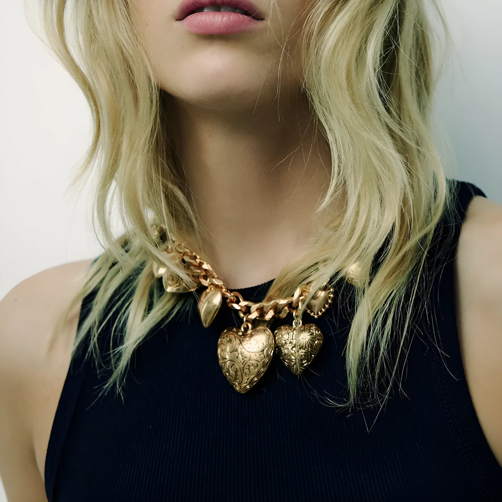 Gold carved heart pendant necklace on adjustable metal chain with exaggerated heart shape