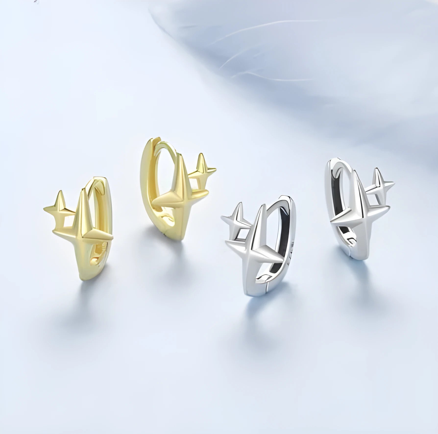 Minimalist sterling silver star-shaped clip-on earrings featuring a XINGX pattern and oxidised finish.