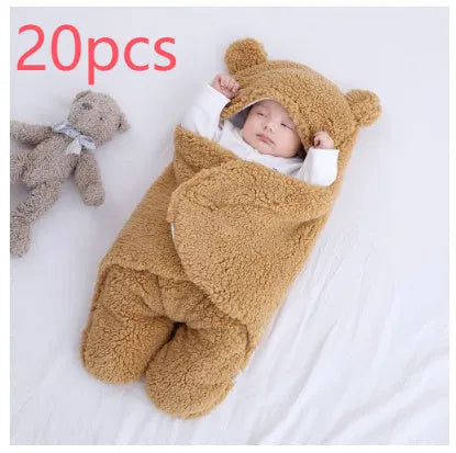 Baby quilted sleeping bag wrapper in cotton blend fabric, shown in grey colour with size tag.