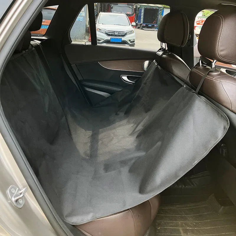 Grey dog bone print water resistant car pet mat measuring 140x110cm on a car rear seat.