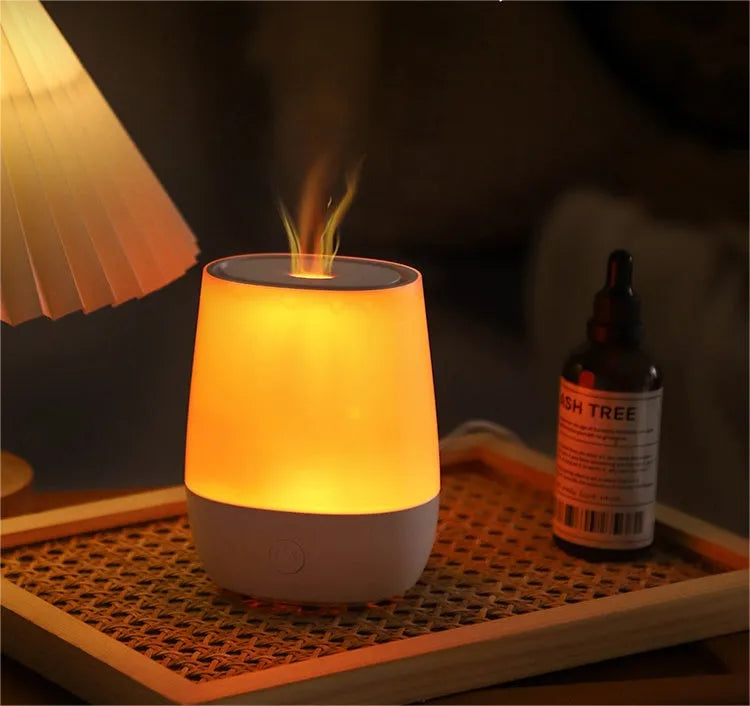 White USB aroma diffuser with simulated flame effect on a wooden surface.