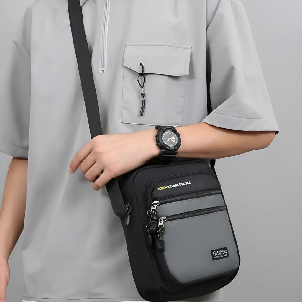 Men's nylon crossbody bag in solid colour with multiple pockets and adjustable shoulder strap