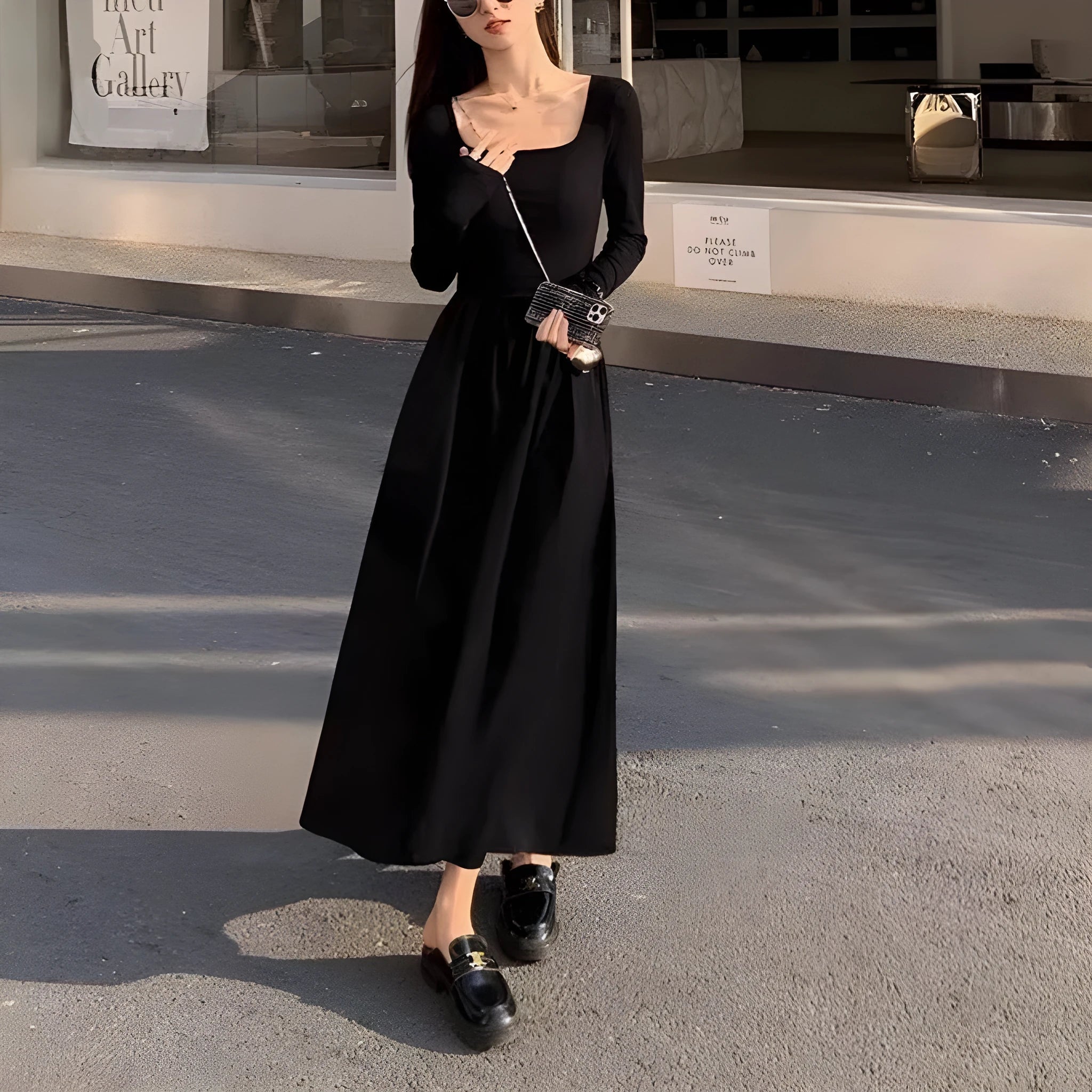 Women's black knitted dress with square collar, long sleeves, elastic waist, and A-line long skirt