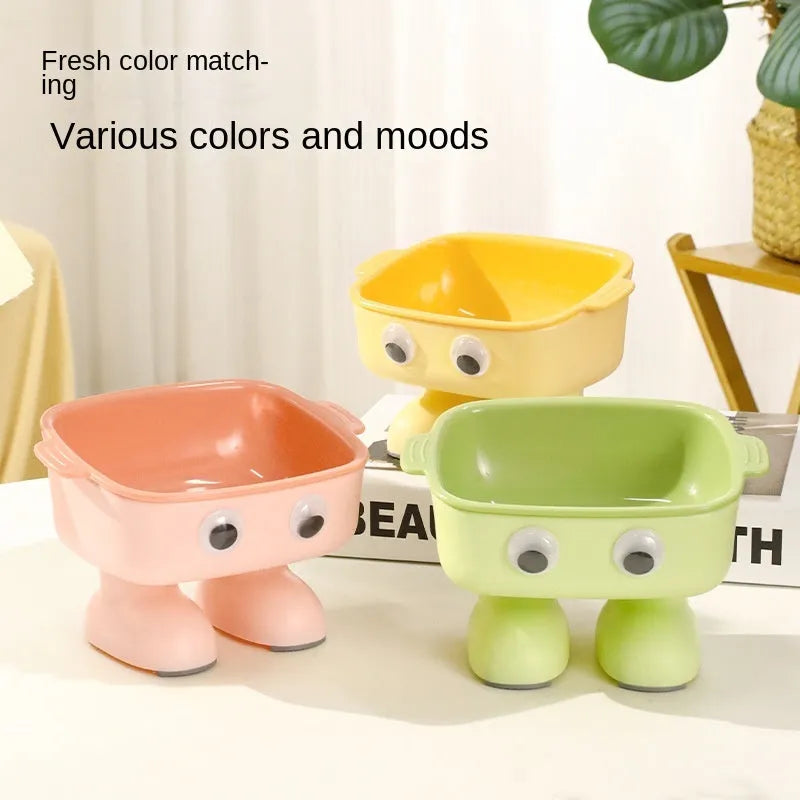 Green robot-shaped tilted cat bowl with detachable inner dish on a non-slip base.
