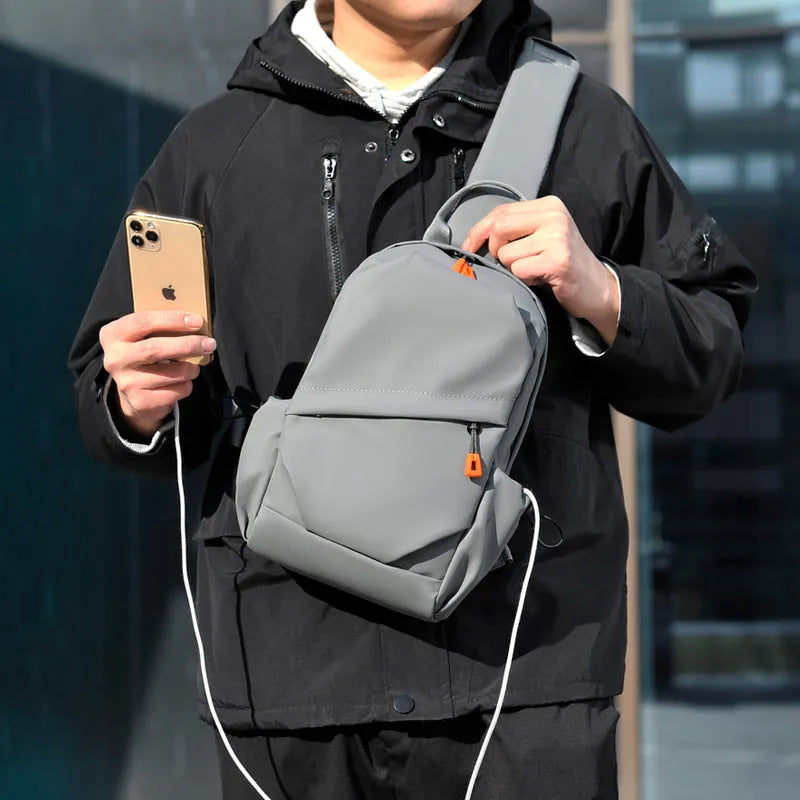 Men's black polyester crossbody bag with single shoulder strap shown in casual setting