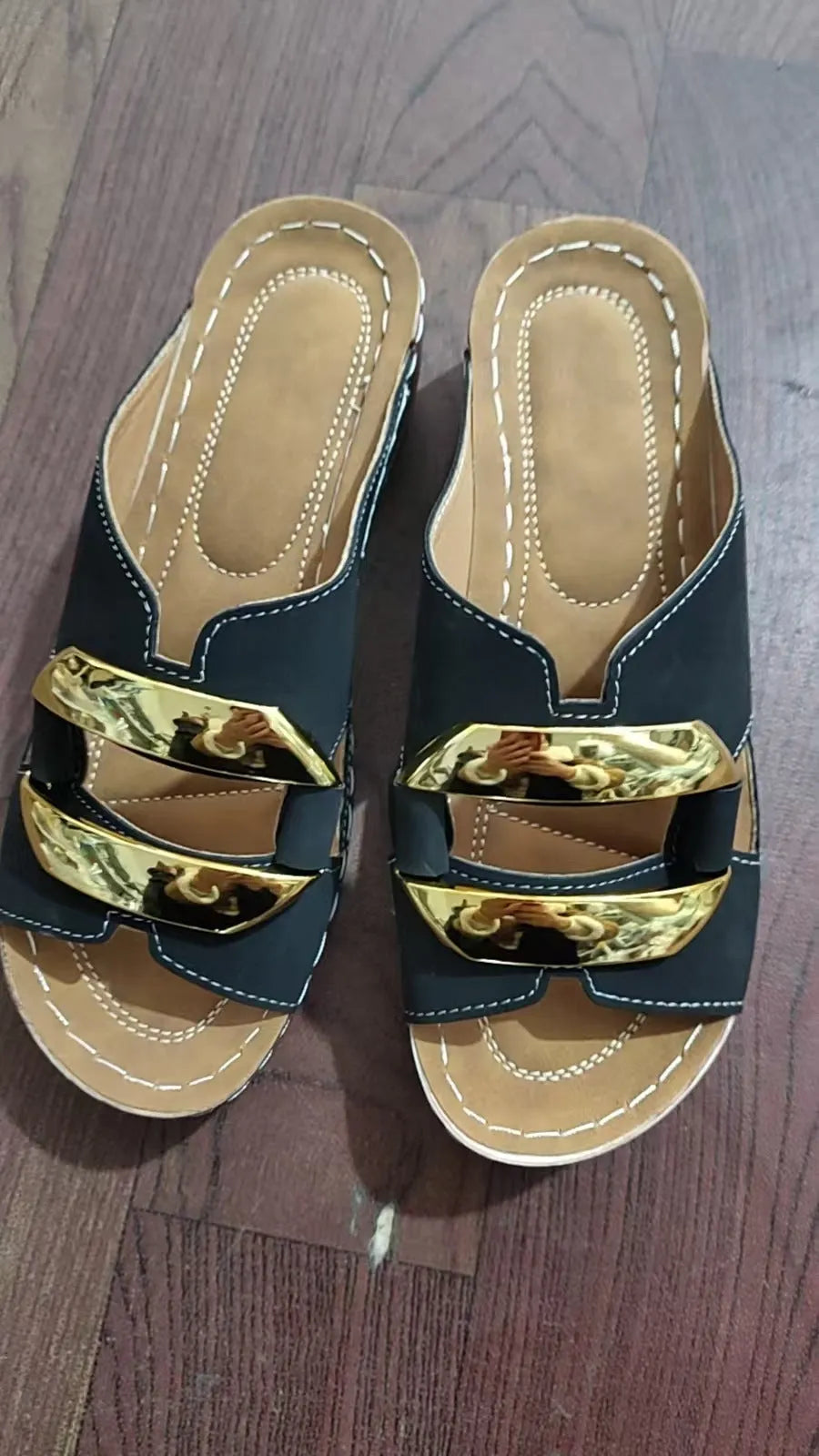 Roman-style platform flip-flop sandals in white, showing flat heel and metal detail.