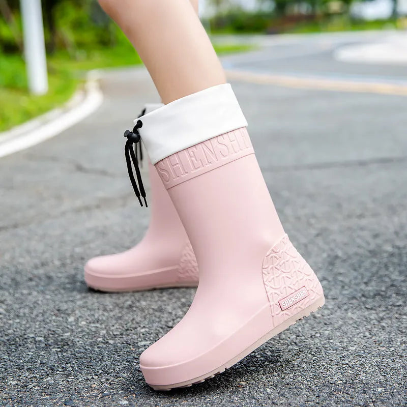 Women's PVC rain boots with non-slip soles in apricot, black, brown, and pink colour options