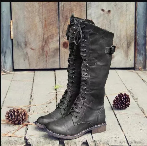 Black chunky heel high leg ankle boots with round toe and low block heel on a plain background.