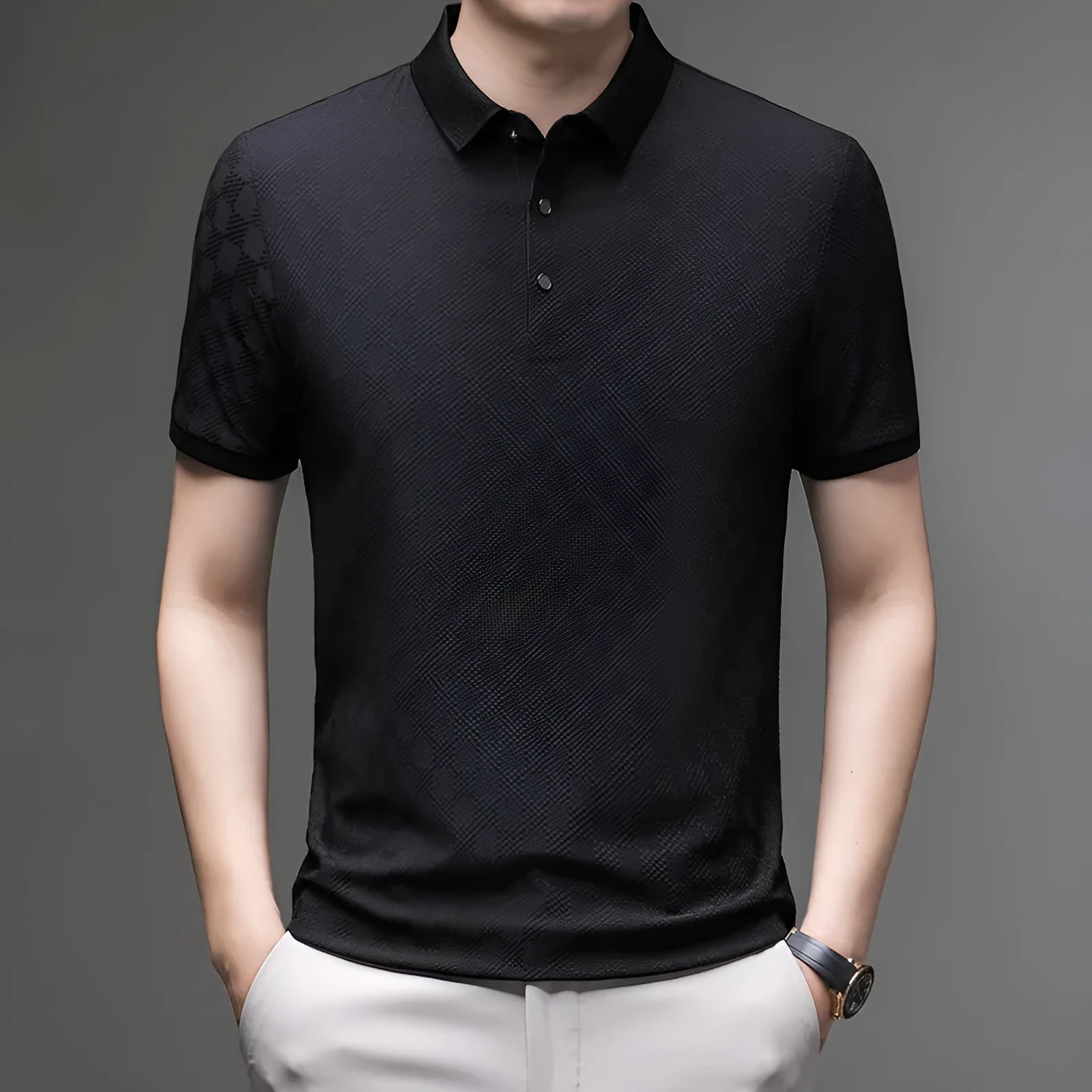 Man wearing a black rhombus patterned short sleeve t-shirt with a side slit detail.