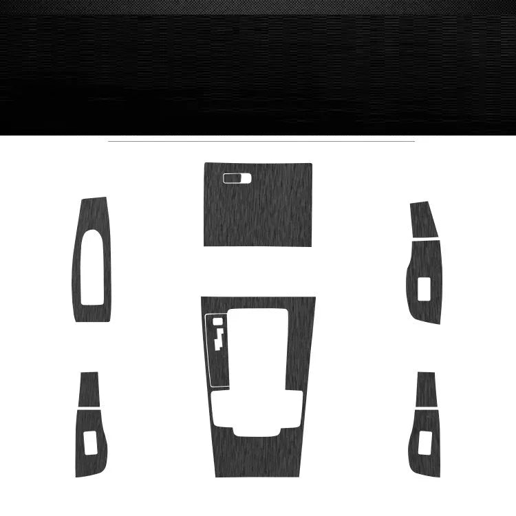 Car interior decorative film sticker kit showing carbon fibre pattern applied to centre console and dashboard
