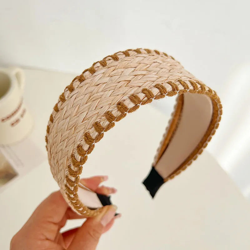 Bamboo woven wide brim hair band in black with bend and hitch details, side view on plain background