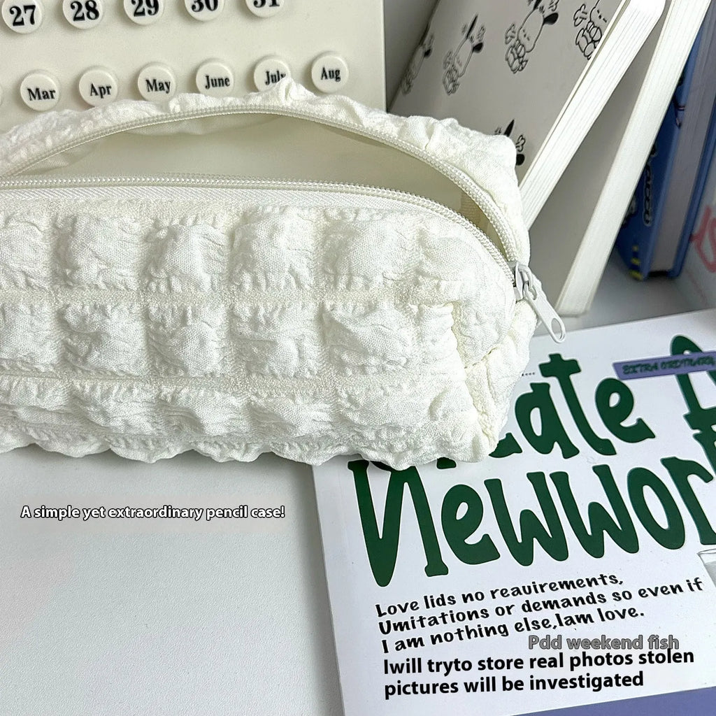 Beige fabric cream puff pencil case with zip closure for pen storage