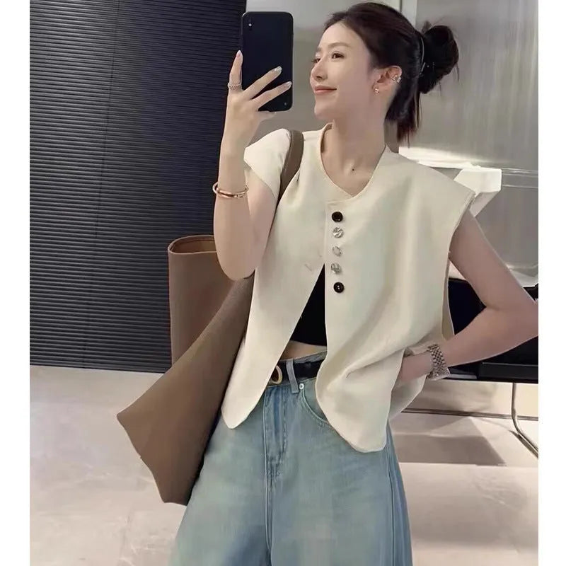 Women's polyester vest in milky white or black with pocket detail and loose fit