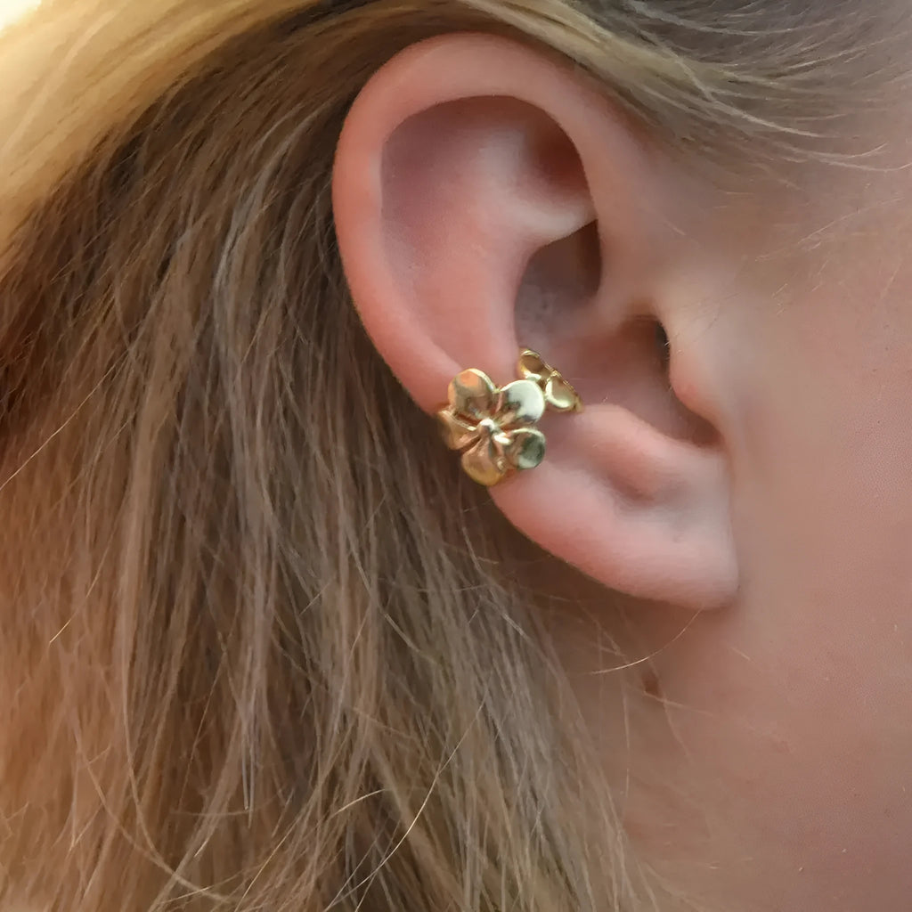 Gold starfish and conch shell earrings for women on a white background.