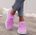 Breathable women's casual flat shoes in flying knit mesh with front lace tie.