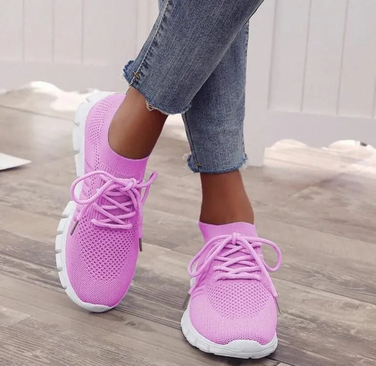 Breathable women's casual flat shoes in flying knit mesh with front lace tie.