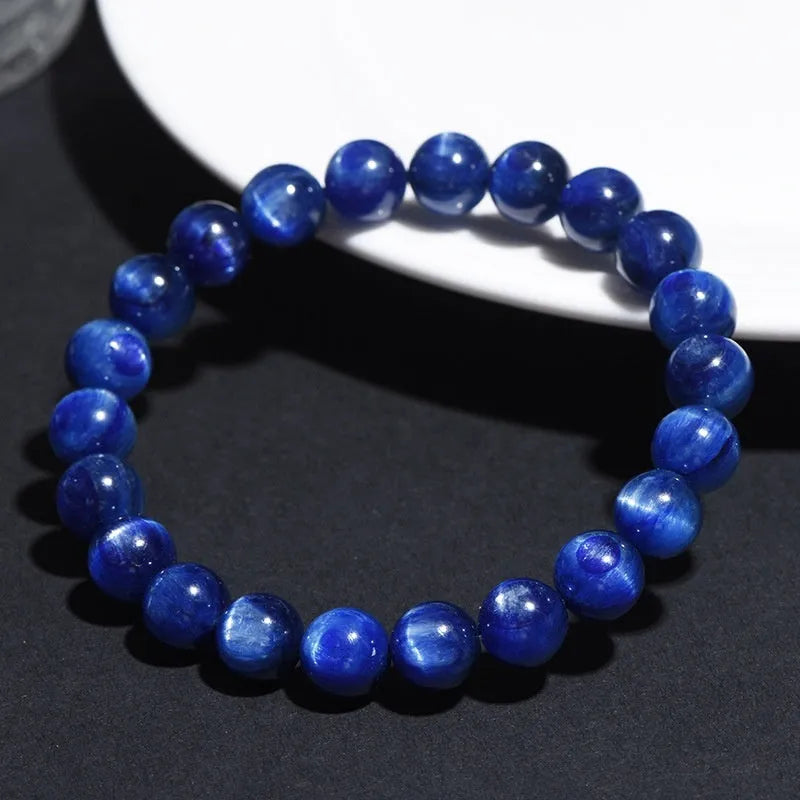 Geometric Ruyi design blue crystal ball bracelet with polished beads on a white background.