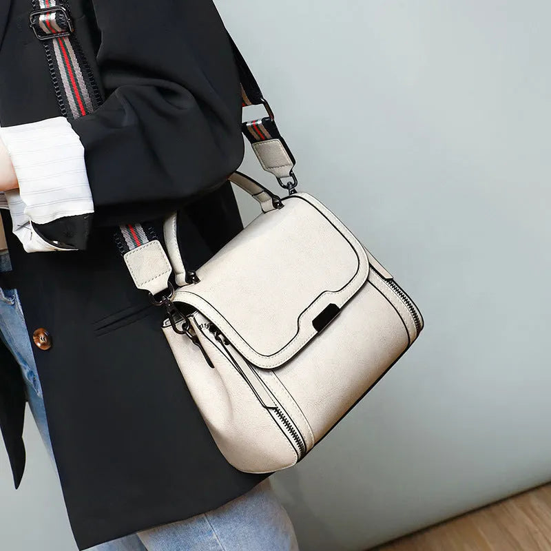 Women's genuine leather messenger bag in horizontal square design with multiple internal compartments