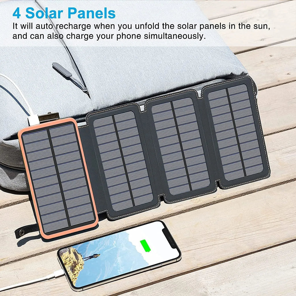 Black solar power bank with a solar panel, LED light, and soft leather exterior, shown outdoors.