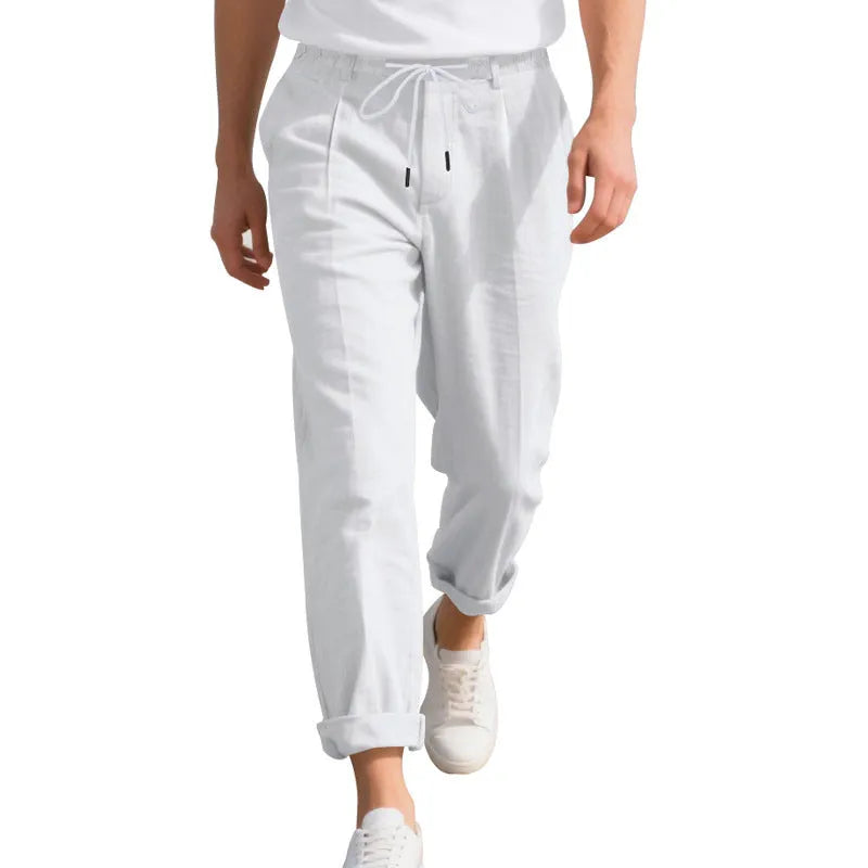 Man wearing light khaki linen casual trousers with a drawstring waist and straight leg.
